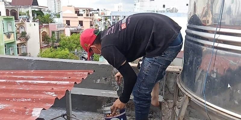 Thi công lớp sơn chống thấm đầu tiên lên bề mặt tường đã được xử lý.