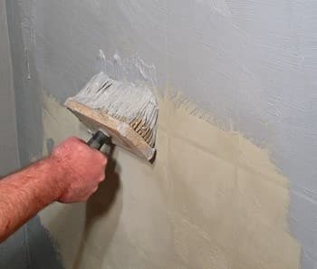 Thợ 1Fix đang kiểm tra và chuẩn bị bề mặt tường ngoài trời trước khi thi công sơn chống thấm.