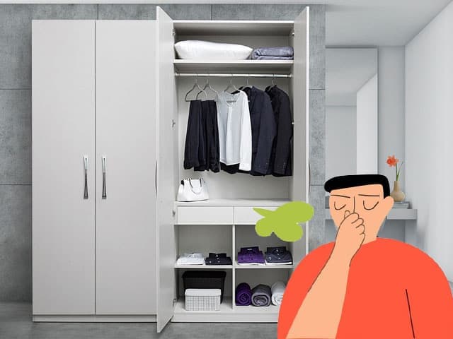 Một người đang cảm thấy khó chịu vì mùi hôi bốc ra từ tủ quần áo mới sơn.