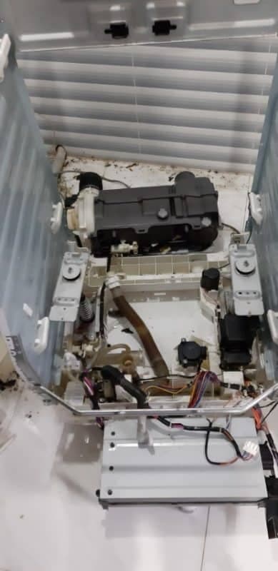 Lồng giặt được nhấc ra khỏi máy để chuẩn bị cho công đoạn xịt rửa